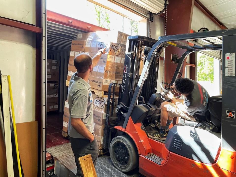 OM Ships :: Sales Representative Stephen Lipham (left) and Florence Warehouse Manager Ross Goodknight (right) load pallets of books to be shipped to ministry partners around the world.